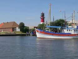 WS Shot of ferry passing from harbor and view of house, North Sea, North Frisia / Busum, Schleswig Holstein, Germany Stock Footage