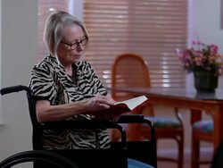 Woman reading book in wheelchair Stock Footage