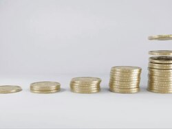 Dollar coins falling into stacks Stock Footage