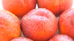 Ripe peaches on the white plate Stock Footage