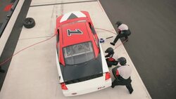 Stock car pit-crew jacks and changes race-car tires Stock Footage