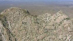 Jagged rock formations jut above the Mojave Desert. Stock Footage