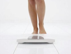 Woman's legs on the white scale. Stock Footage