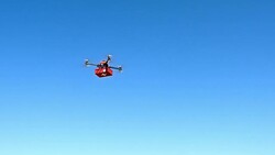 Drone transporting a first aid kit across sky Stock Footage