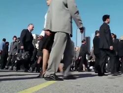 Low angle medium shot crowd of businesspeople walking back and forth / stopping + checking watch Stock Footage
