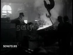 1942: SHIP BUILDING: Metal foundry w/ men moving, stirring, pouring molten metal. Crank shaft turning w/ liquid pouring over. Machine cutting, trimming metal. Worker standing in revolving bulkhead door. Machine grooving turning metal. WWII Instructional Video