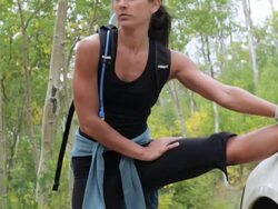 Hispanic woman stretching on car before running Stock Footage