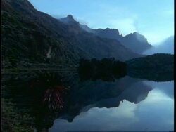 WA dark mountains reflected in still lake, Uganda, Africa Stock Footage