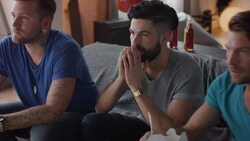 Guys sitting on couch watching tv disappointed Stock Footage