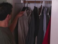 MS Man looking in his closet and grabbing a shirt off the rack / Portland, Oregon, United States Stock Footage