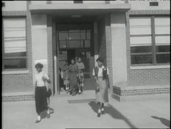 Young African American girls exit a high school building. News Clip