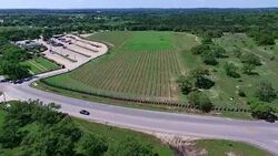 Really High angle Overlook to close to crops Aerial Wine to Market or Farm to Market in Austin Texas Stock Footage