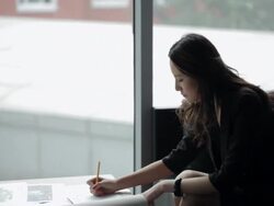 TD MS Young business woman writing, sitting at coffee table by window/ Beijing, China Stock Footage