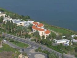 Aerial modern shaped house on edge of the Sea of Galilee, also known as Lake of Gennesaret, Lake Kinneret, Sea of Tiberias or Tiberias Lake, Israel Stock Footage