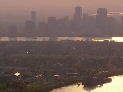 Aerial view of sun setting over downtown from Chalmette / New Orleans, Louisiana Stock Footage