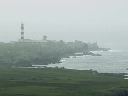 WS AERIAL DS Shot of lighthouse and waves crashing on rocks / Brittany, France Stock Footage