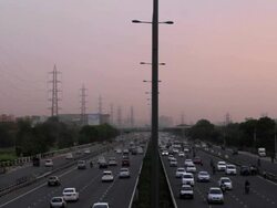 Busy traffic at the Delhi-Gurgaon expressway, a part of national highway 8, at Udyog Vihar, Gurgaon, Haryana Stock Footage