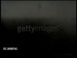 1930s: JAPAN: RISE OF MILITARISM: TRACKING Japanese soldiers w/ bugler, most in silhouette, running left across smoky landscape. Angled MS Japanese soldiers w/ vegetation on helmets running up path outside village.   Dark, poor contrast. Instructional Video