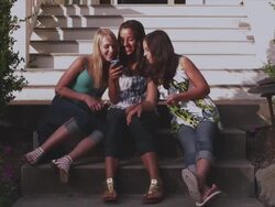 MS Three girls sitting out in front of home / Portland, United States   Stock Footage