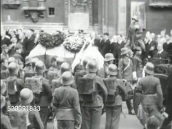 1934: DOLLFUSS FUNERAL: Procession w/ Caisson & coffin moving in streets, 1934: ITALY: MS Italian Fascist dictator Benito Mussolini in uniform speaking, gesturing on balcony (No SOT). Instructional Video