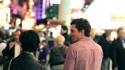Young couple walk through colorful downtown Las Vegas Stock Footage