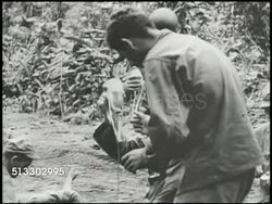 1943: BOUGAINVILLE CAMPAIGN: VS U.S. 3rd Marine Division infantry soldier w/ bandaged head, medics starting IV for wounded soldier, soldiers running w/ body on stretcher (could be Killed in Action, KIA, unconfirmed). WWII, Pacific Front Instructional Video