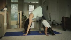 Pregnant mother doing yoga in her home with her toddler Stock Footage
