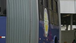 A sign on the side of a bus announces a biofuel vehicle. Stock Footage