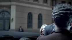 Chauffeur opens limousine door for celebrity couple who pose for cameras at red carpet premiere at awards show Stock Footage