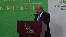 Blatter hands over World Cup trophy to Rousseff, Valcke at media centre News Clip