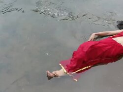 Woman lying on water, Malshej Ghat, Maharashtra, India Stock Footage