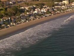 Aerial TS WS along residential beachfront homes / Malibu, California, United States.  Stock Footage