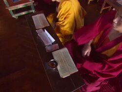 MS PAN Young boy at  Buddhist monastery bows towards his paper  AUDIO / Kathmandu, Central Region, Nepal  Stock Footage