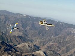AIR TO AIR, WS, Two Aero L-39 Albatroses flying over Mojave Desert hills, California, USA Stock Footage