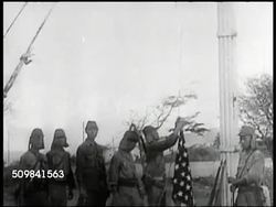 1942: 'CORREGIDOR SURRENDERS': CU Newspaper. WS Japanese soldiers replacing American flag w/ Japanese flag. General Jonathan M. 'Skinny' Wainwright (1883-1953) (R) standing w/ soldier. VS Japanese soldiers entering house, walking w/ flag. Philippines. Instructional Video