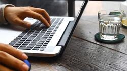 Handsome young businessman working at laptop with cup of coffee Stock Footage