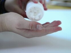 Pouring pills into hands Stock Footage
