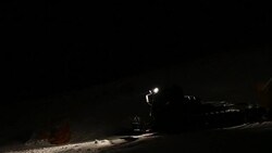 Machine for leveling the ski slopes works at night. Stock Footage