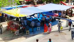 A plastic covered street vendor in the hot month of June in Delhi Stock Footage