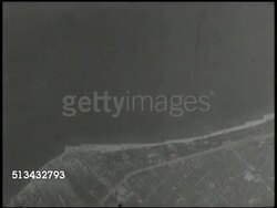 1945: B-29 SUPERFORTRESS BOMBER AIRPLANE: VS B-29 Superfortress dropping aerial bombs over industrial areas of Japan landscape, explosions. World War II, WWII, airstrike, bombing run, Pacific Front Instructional Video