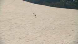 Hikers cross a vast, snowy glacier. Stock Footage
