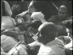 Mourners gather around the body of Mahatma Gandhi after his assassination in 1948. News Clip