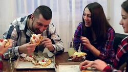 Family or friends sharing a pizza Stock Footage