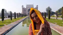 Woman with Taj Mahal entrance at the back Stock Footage