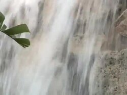 Decorative waterfall in a botanical garden; focus on the leaves Stock Footage