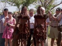 WS Shot of group of tourists taking photos of two imba women / Imba Village, Namibia Stock Footage