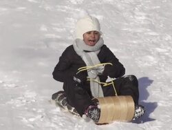 Girl has fun sledding on a winter day Stock Footage