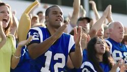 Stadium crowd cheers at football game Stock Footage
