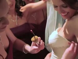 bride checks out dress in mirror as bridesmaid help with makeup Stock Footage