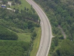 WS AERIAL View of cars running on highway and farm fields / Rhone Alpes, France Stock Footage